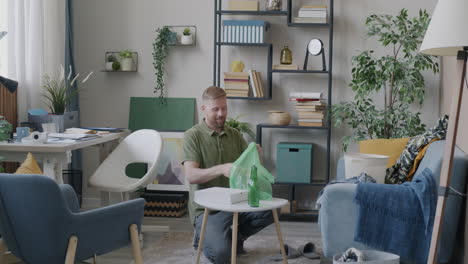man sorting trash in a living room