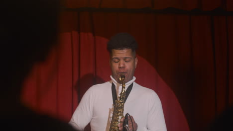 Latin-Man-Finishes-Playing-Sax-In-Live-Music-Perfomance