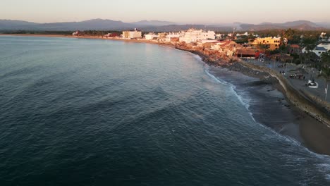 ocean waves crash on coastline of barra de navidad jalisco mexico, aerial dolly