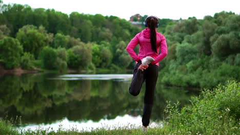 the girl warms up early in the morning before training preparing for a run in the sun