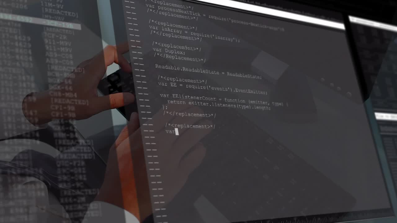 Male developer typing on keyboard at glass desk, causing app code filling monitor reflecting hands