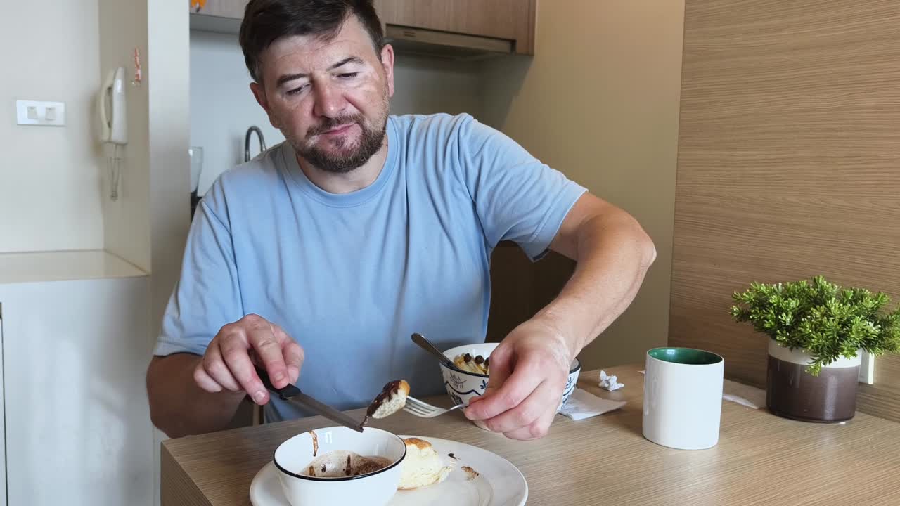 Man eating breakfast at a table