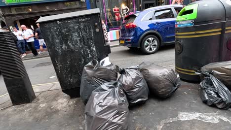 pedestrians and trash bags on a city street