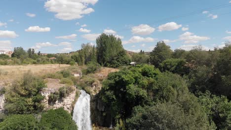 Tiro-De-Drone-Ascendente-Mirando-Hacia,-Luego-Más-Allá-De-La-Cascada-El-Hundimiento-En-Lagunas-De-Ruidera,-España