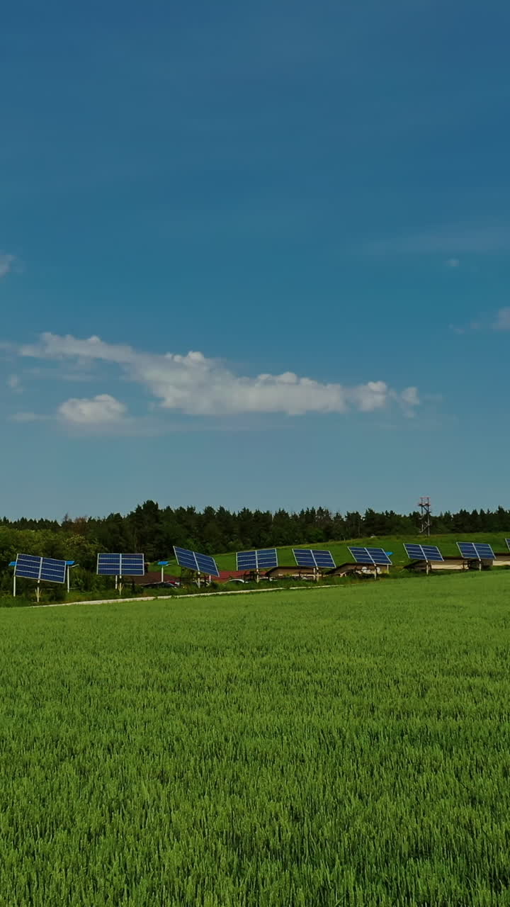 Innovative solar panels on field. Agricultural landscape in spring and photovoltaic solar cells to receive green energy from the sun. Ecological electricity. Vertical video