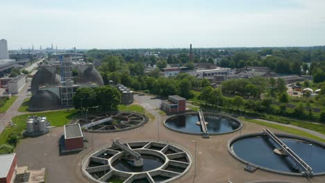 backwards reveal of circle sump tanks in wastewater treatment plant. purification of water before discharging it into river. luebeck, schleswig-holstein, germany