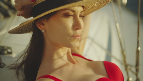 woman in a straw hat and red bikini on a yacht