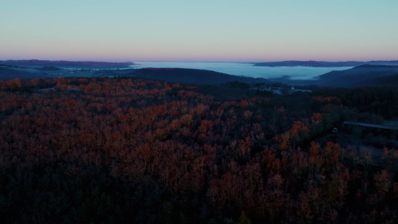 Aerial view of sunset over the hills with mist