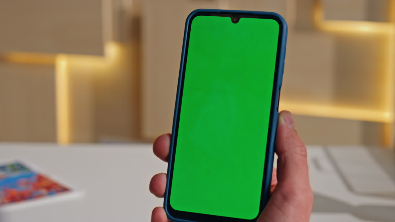 Employee scrolling chromakey mobile phone surfing internet in office close up.