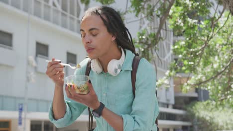 mixed race man eating outside