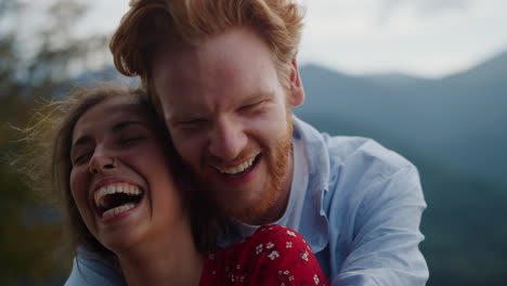 cheerful couple laughing mountains. closeup happy people face spending honeymoon