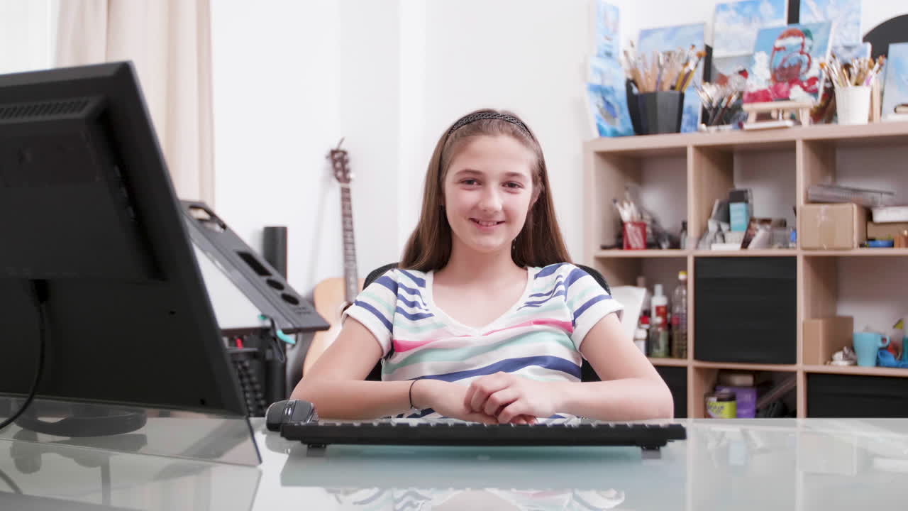 Girl at a desk with a computer and drawing table