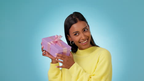 woman, smile and shake gift box in studio