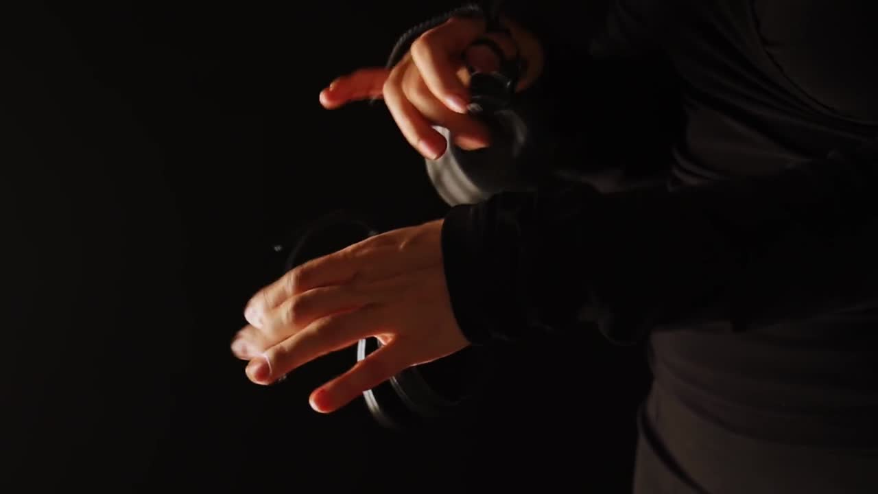 Close up of hands playing castanets in flamenco performance. Handheld