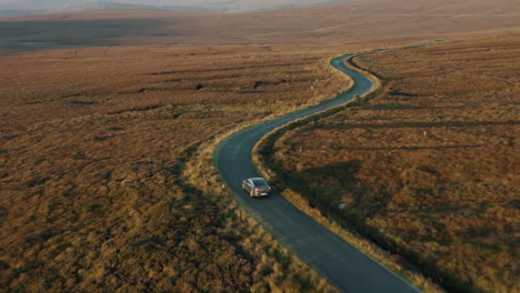 aerial view, car driving through the wicklow mountains, ireland