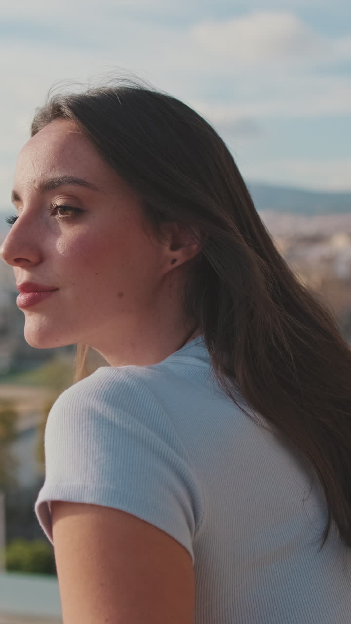 Woman on a rooftop overlooking the city
