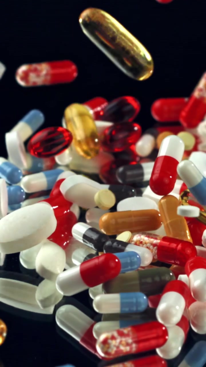 Pharmaceutical Pills and Capsules Falling in Slow Motion