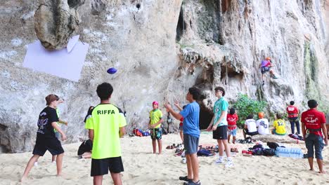 tourists playing volleyball on krabi beach