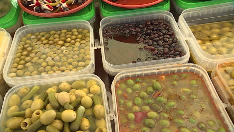 assortment of olives and pickled vegetables at a market