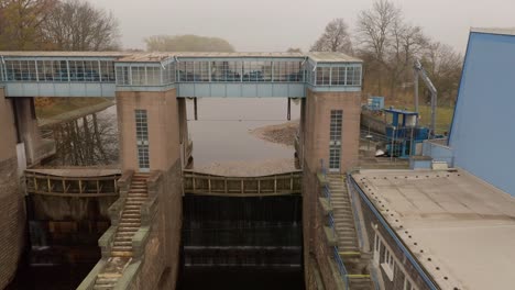 Drohnenaufnahme-Des-Kleinwasserkraftwerks-Smirice-Am-Tschechischen-Fluss-Elbe-An-Einem-Nebligen-Tag