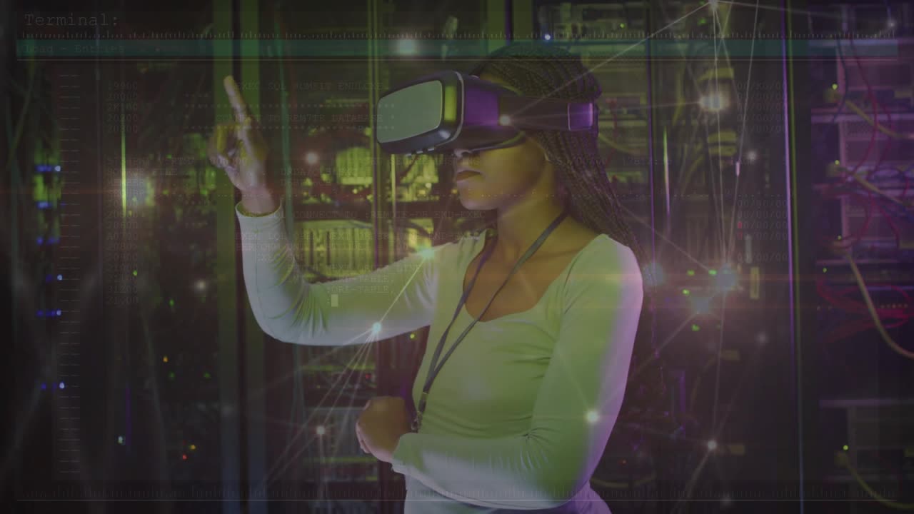 Engineer wearing VR headset in server room extending finger tapping pulsing network nodes testing