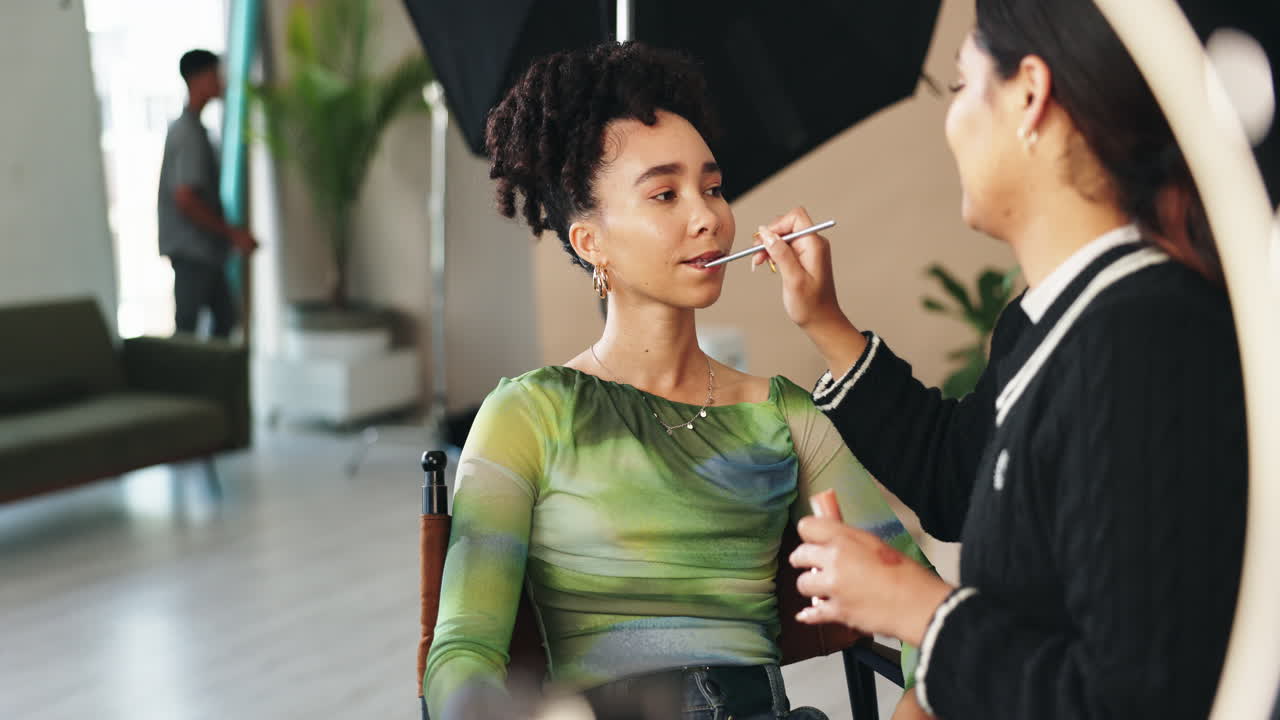 Makeup Artist Applying Lipstick