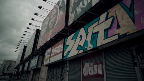 abandoned city street with graffiti covered billboards