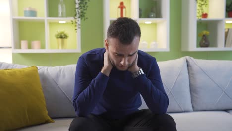 unhappy, depressed man is thoughtful and not feeling well at home.