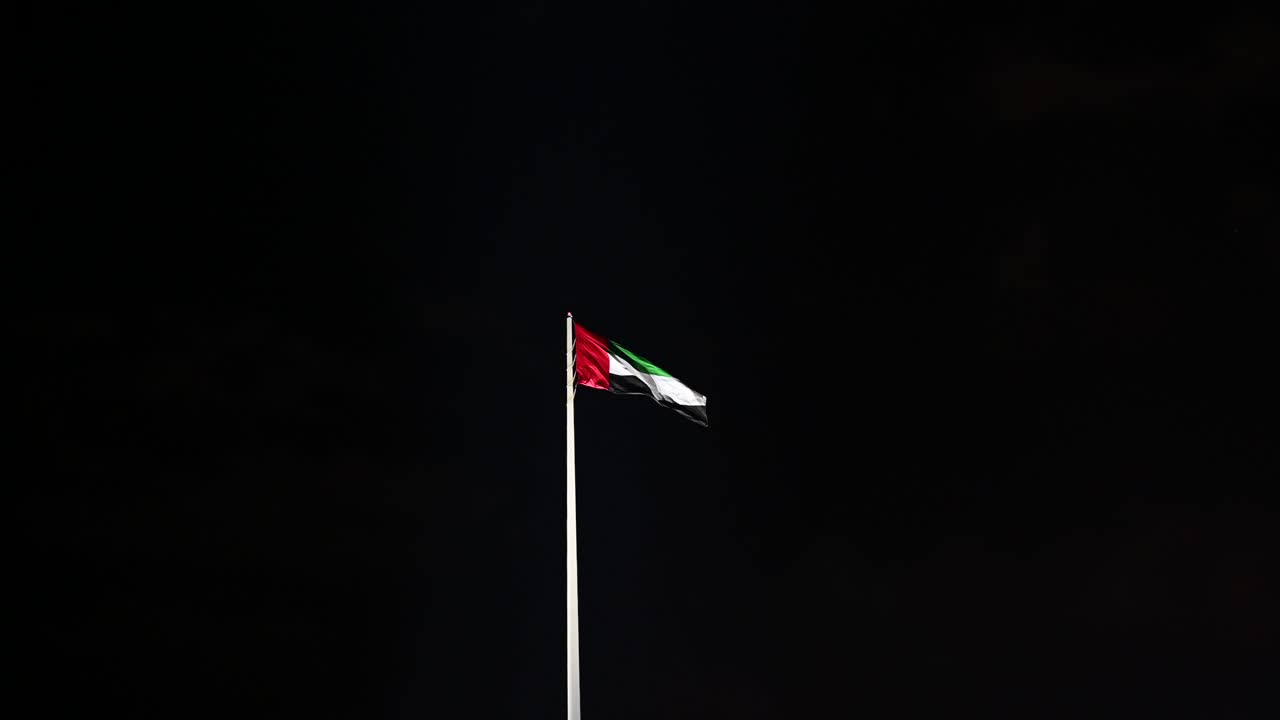 The Flag of UAE under the clear night sky, The national symbol of the United Arab Emirates