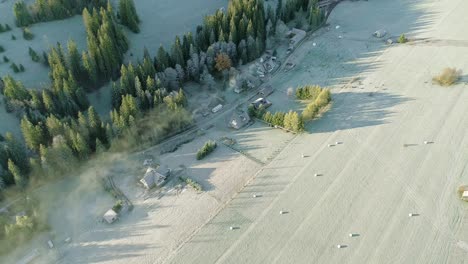 Poland-countryside-with-several-farmstead-next-to-grassland-at-dawn,-aerial