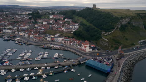 establishing drone shot of scarborough town and castle on overcast morning