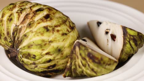 custard apple sliced and displayed on a plate