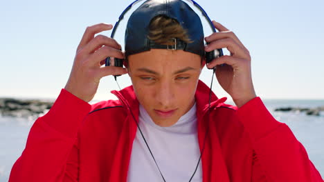 Man,-music-headphones-and-face-at-beach-for-summer