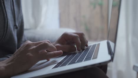 Hands-type-on-computer---working-comfortably-from-home