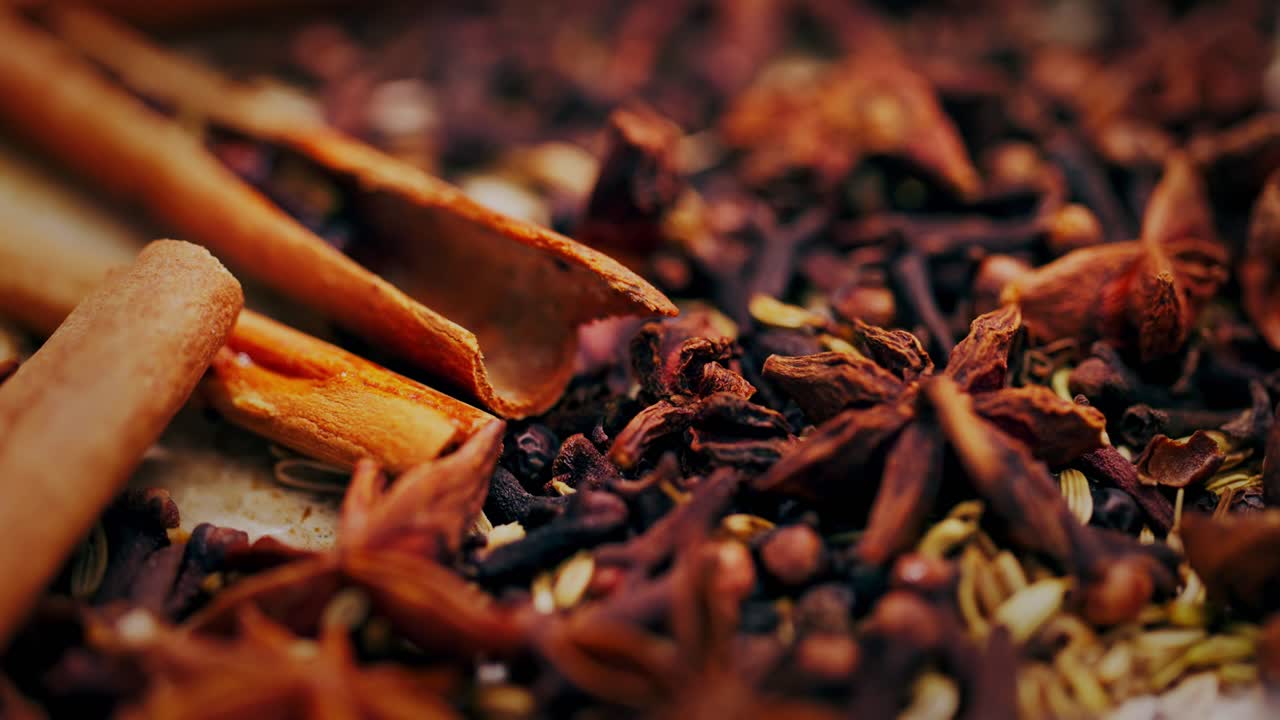 Spice mix with cinnamon on a frying pan with pouring water, close up