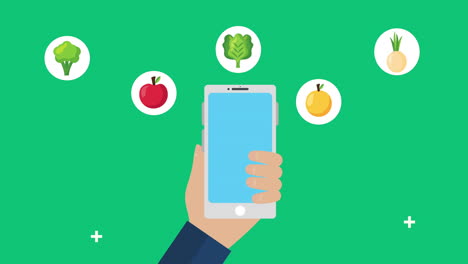 mano usando el teléfono inteligente con alimentos frescos y saludables