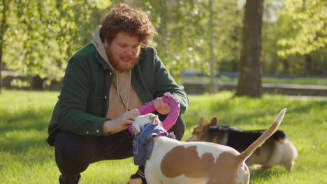 man playing with his dog in a park
