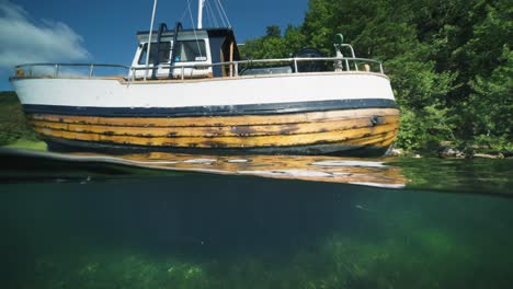 a wooden old-school boat moored near the shore