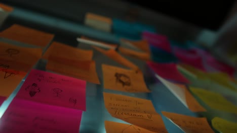 close-up of colorful sticky notes on a reflective surface