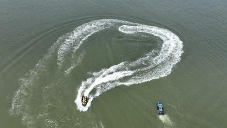 an aerial view over gravesend bay in brooklyn, ny as two jet ski riders enjoys the beautiful day together