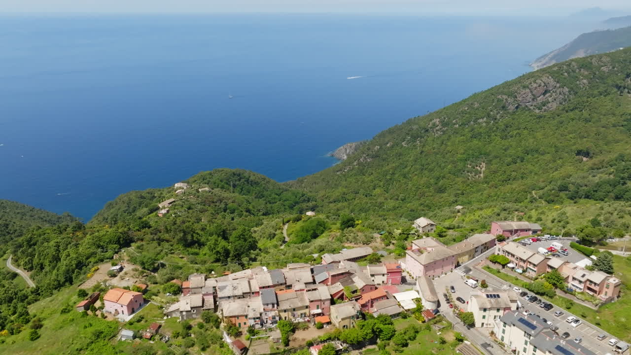 Drone circling the Montaretto village and the coastline of Liguria, summer day