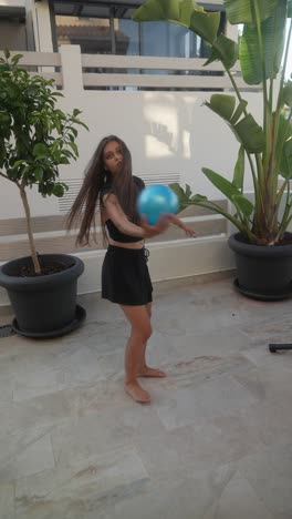 teenager playing with a ball on a patio