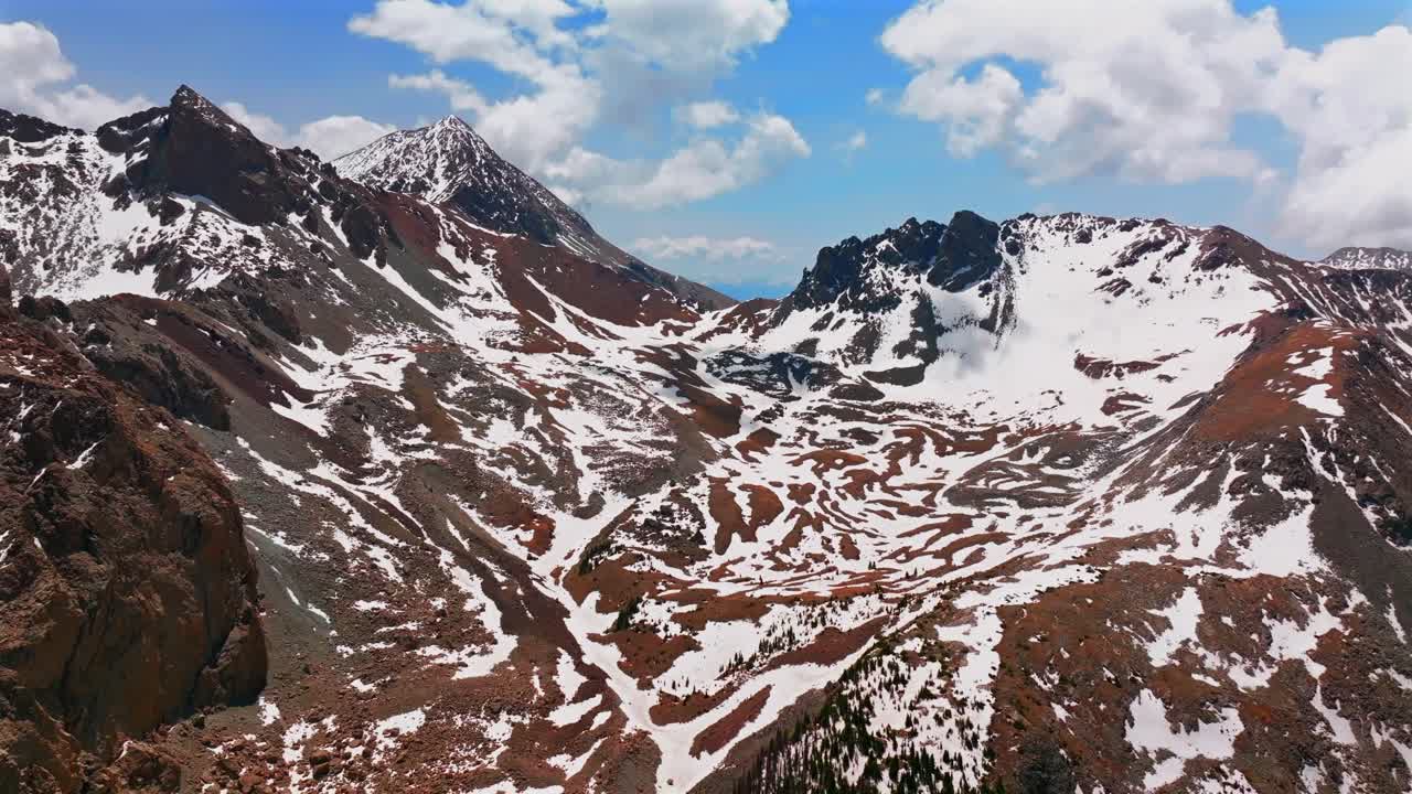 Mt Mount Lindsey Sangre De Cristo Range aerial drone Colorado spring summer snow fields melting morning blue sky clouds high Rocky Mountains summit Sierra Blanca Massif Fort Garland forward motion