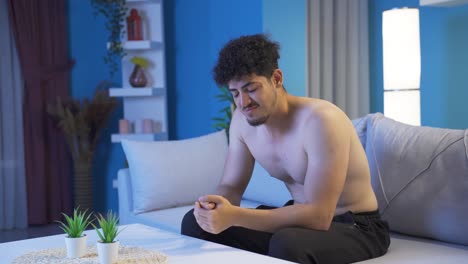 joven abrumado y abatido por la noche en casa.