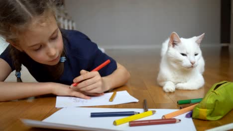 little girl drawing with pencil at home.