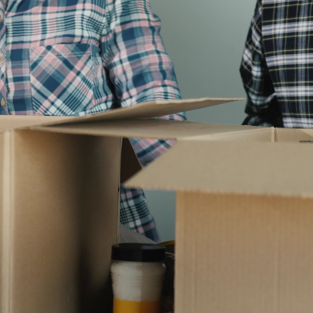 People Pack Canned Food And Other Food In Boxes