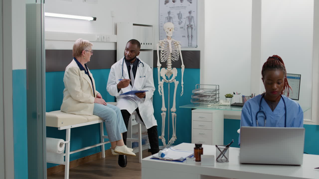 Doctor consulting with senior woman in clinic