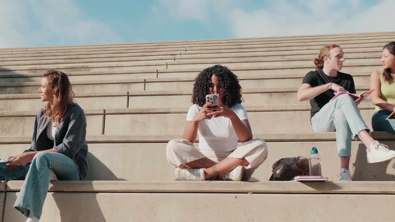 Millennial group of happy young students friends sitting outdoors, zoom