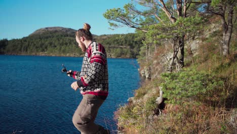 Man-Fishing-On-A-Lake-In-Hildremsvatnet,-Norway---wide