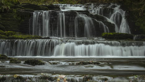 time lapse of forest waterfall in rural landscape during autumn in ireland